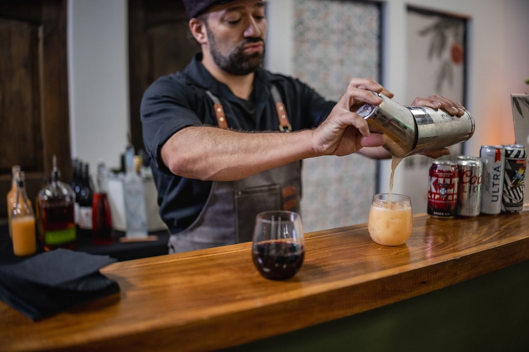 Bartender pouring a cocktail at an event